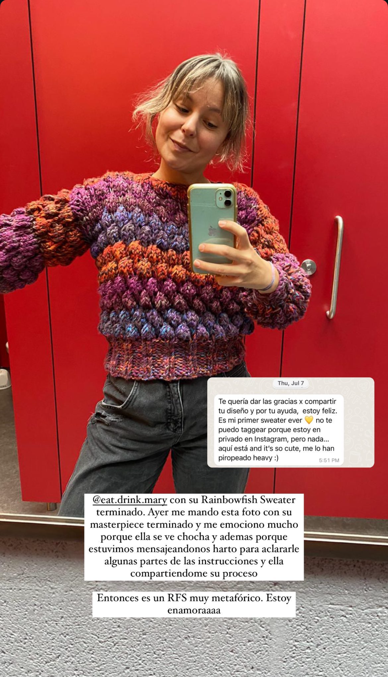 Person wearing a colorful sweater taking a mirror selfie with a red background